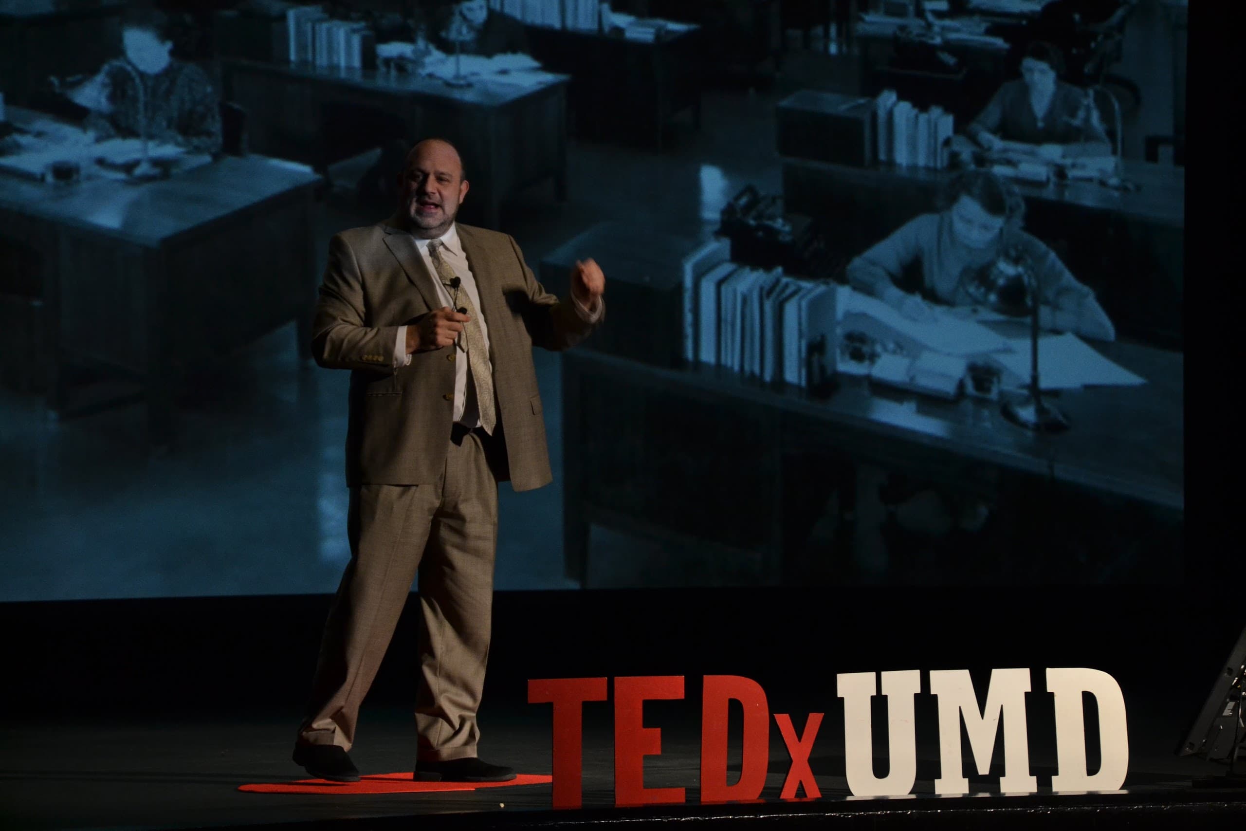 Dr. Rob Furman speaking on a TEDx stage
